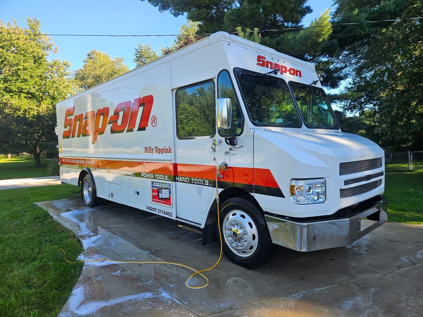 Commercial service truck being pressure washed by Custom Klean
