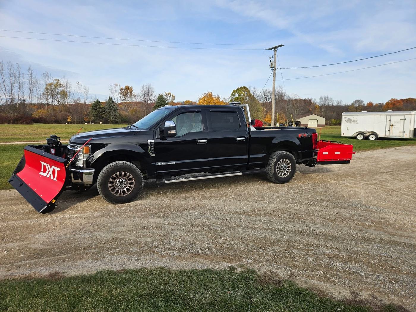 Custom Klean plow truck with attached DXT snow plow and equipment trailer